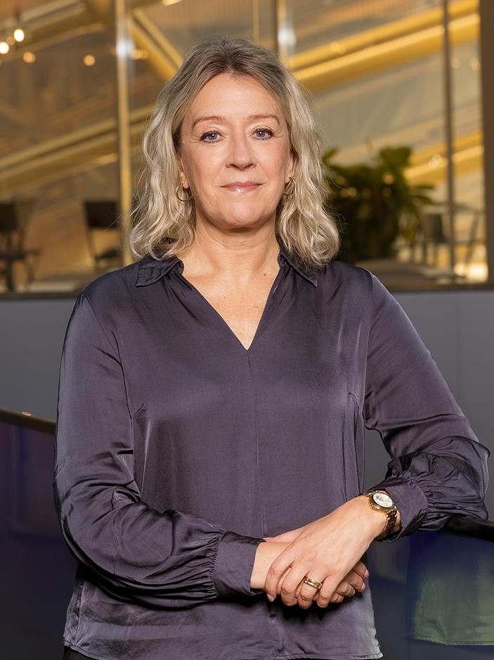 Eva Brike smiling in office.